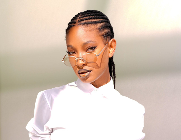 Willow Smith wears braids and a lined frosted lip at a Dior fashion show.